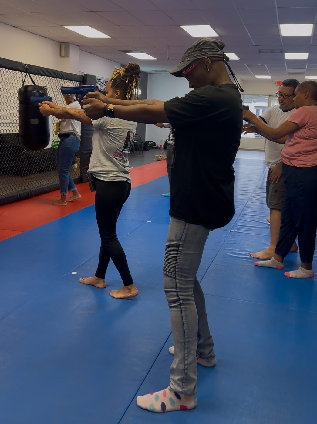 Women in a line practicing SIRT pistol training together
