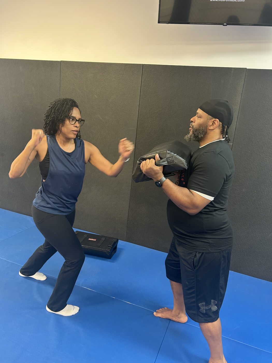 Tanja mid-strike on pads during Crowned by Fire training